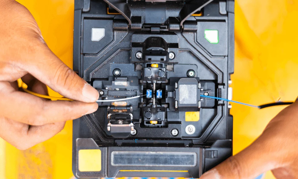 Engineer performing optical fiber fusion splicing